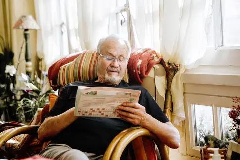 photo of senior man working crossword