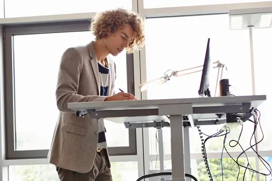 photo of man working at standup desk