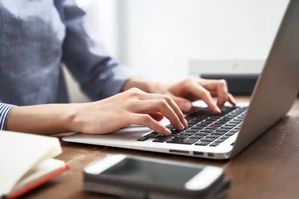 photo of woman working on laptop at home